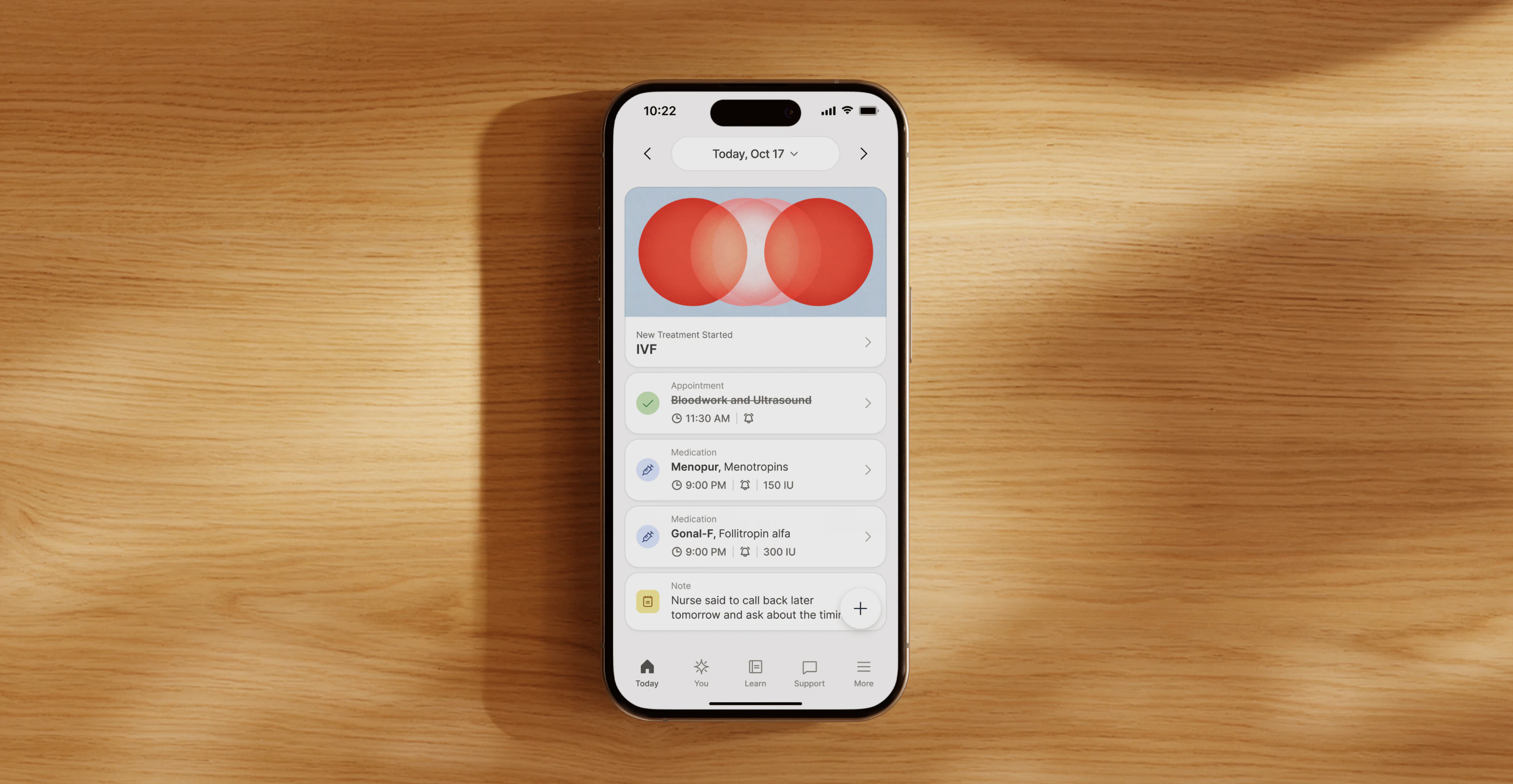 Berry's treatment dashboard shown on a phone resting on a wooden table