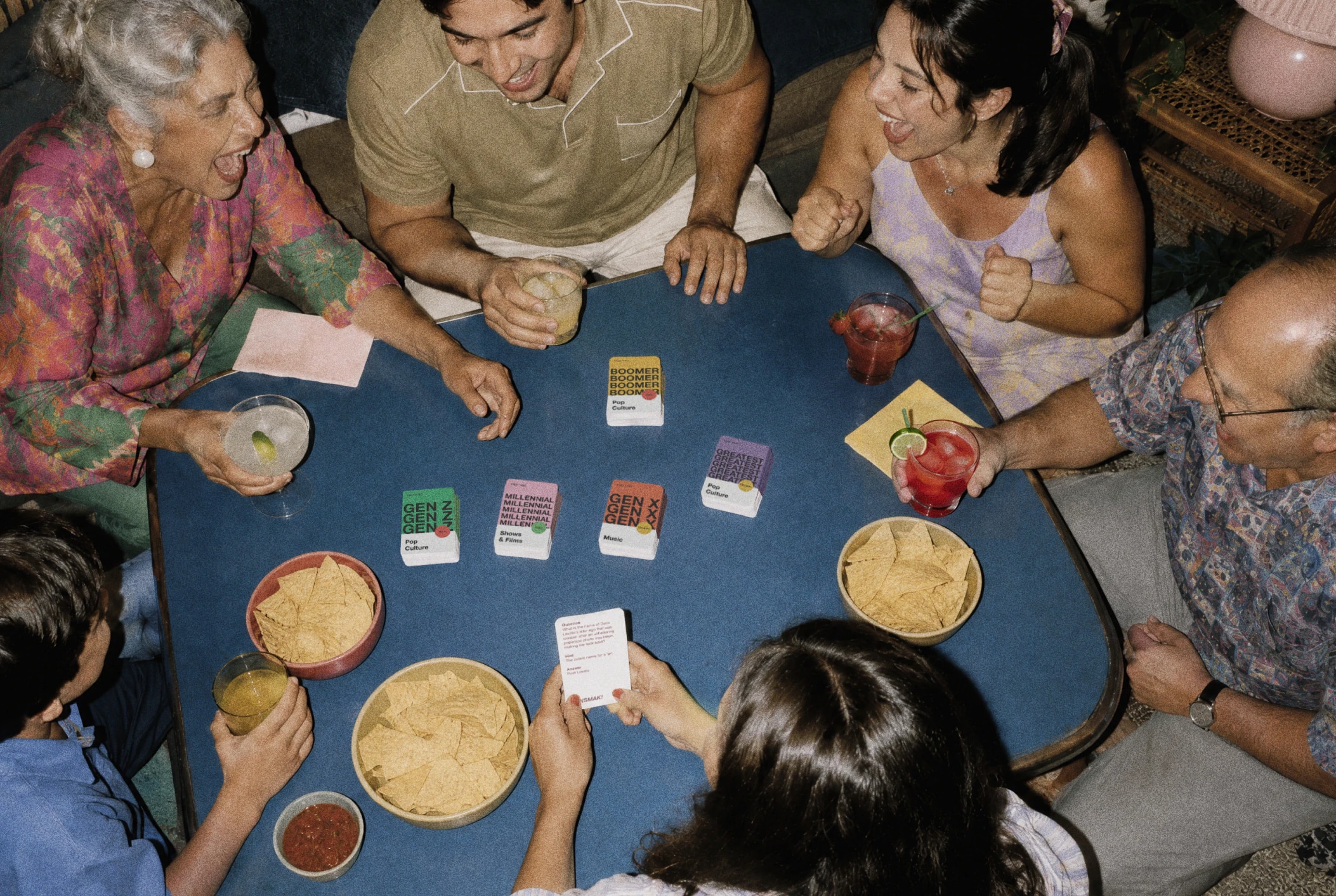 Family and friends playing GENSMAK! around a table