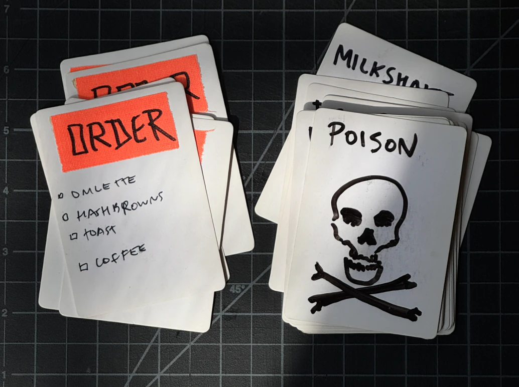 Handwritten order and poison cards from an early game prototype